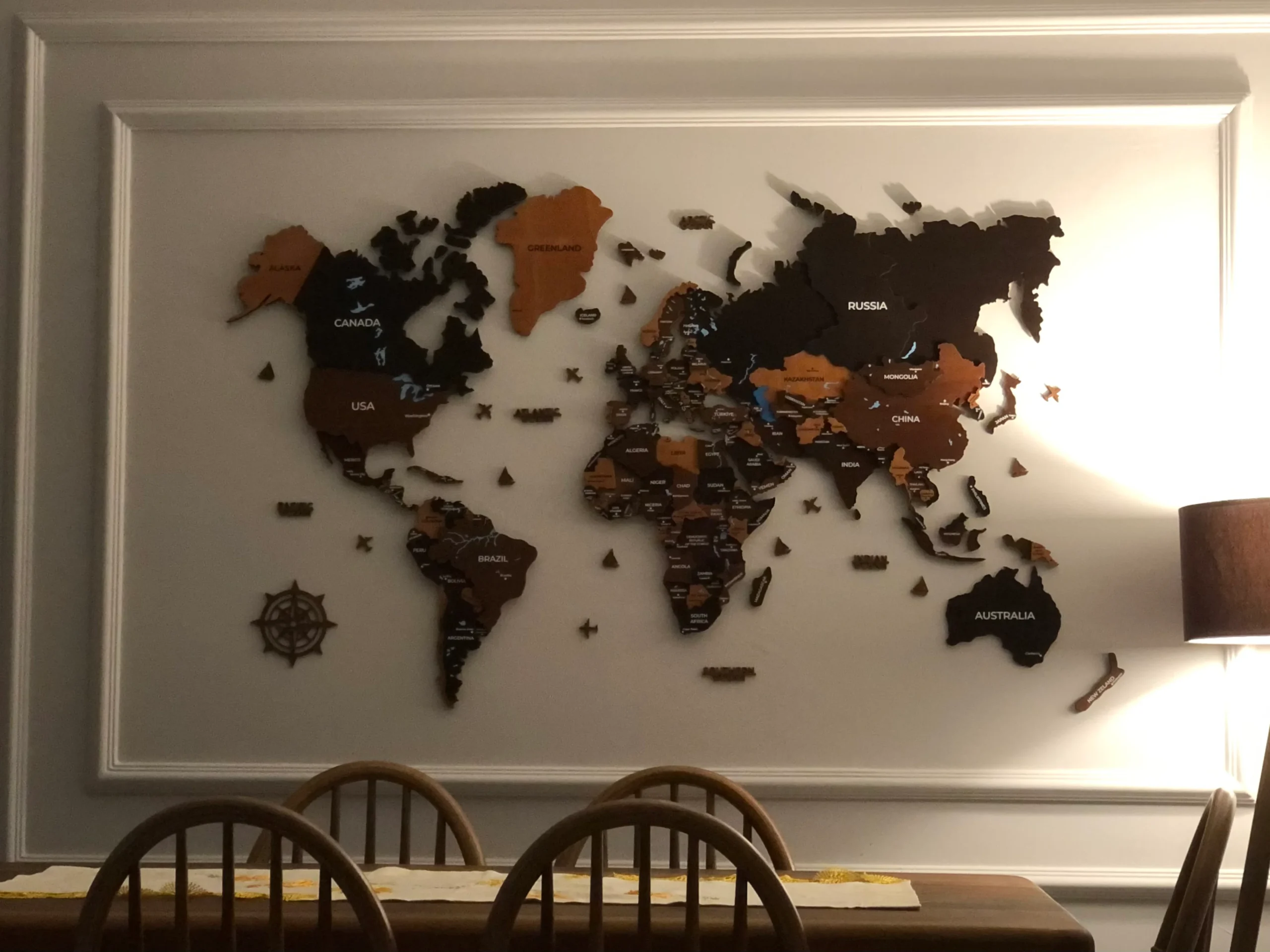 Large wooden world map over dining area – customer photo